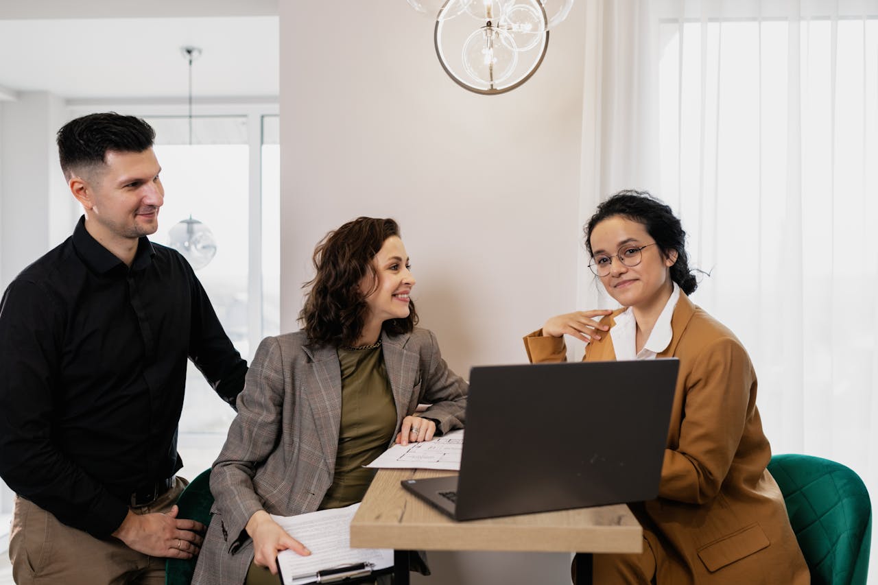 Services-02 Professional business meeting with real estate consultant and couple in an office setting.