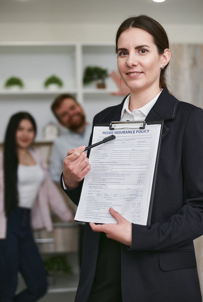 creative-03 Confident businesswoman presenting a home insurance policy indoors to potential clients.